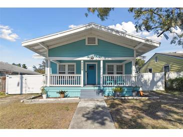 Charming bungalow with a teal exterior, white trim, and a welcoming front porch at 111 W Ida St, Tampa, FL 33603