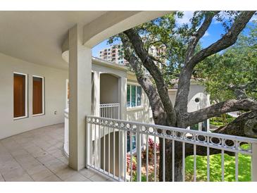 Spacious balcony overlooking lush landscaping and mature trees at 3507 Bayshore Blvd # 102, Tampa, FL 33629