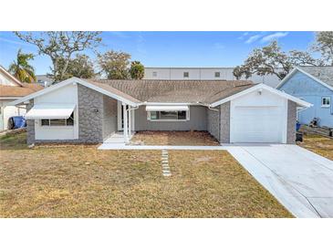 Cute one-story home with gray stone accents and a two-car garage at 4024 Jib Sail Ct, New Port Richey, FL 34652