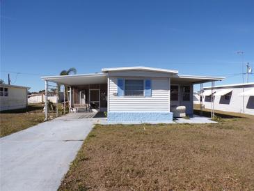 Single-wide manufactured home with carport and small yard at 5341 Mary St, Zephyrhills, FL 33542