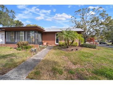Brick ranch home with carport, mature landscaping, and a spacious yard at 2320 Shelly Dr # B, Palm Harbor, FL 34684