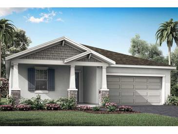 One-story home with gray siding, stone accents, and a two-car garage at 5029 124Th E Ave, Parrish, FL 34219