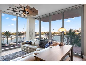 Living room with water views, comfortable seating, and a stylish wooden coffee table at 5120 Marina Way # 2208, Tampa, FL 33611