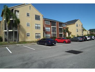 Apartment building with parking lot and palm trees at 11901 4Th N St # 10105, St Petersburg, FL 33716