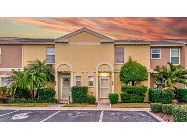 Attractive yellow townhome with landscaping and parking at 1505 Chateaux De Ville Ct, Clearwater, FL 33764