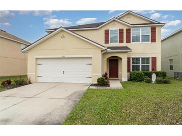 Two-story house with a large garage and landscaped lawn at 15737 High Bell Pl, Bradenton, FL 34212