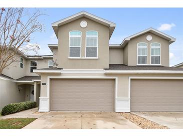 Two-story townhome with a two-car garage and neutral color scheme at 1950 Marlington Way, Clearwater, FL 33763