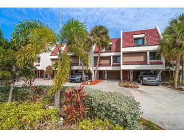 Attractive townhouses with red tile roofs, lush landscaping, and private parking at 224 Skiff Pt # 224, Clearwater Beach, FL 33767