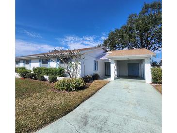 White single story home with carport and landscaped lawn at 2241 Greenwich Dr # 2241, Sun City Center, FL 33573