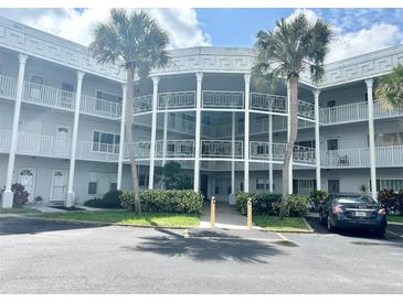 Condo building exterior with palm trees and parking at 2449 Columbia Dr # 55, Clearwater, FL 33763