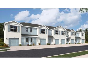 New townhouses with light blue garages and white exterior at 4652 Pleasant Ave, Palm Harbor, FL 34683