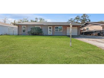 Ranch style home with a large yard and attached garage at 6512 2Nd Ave Ne, Bradenton, FL 34208