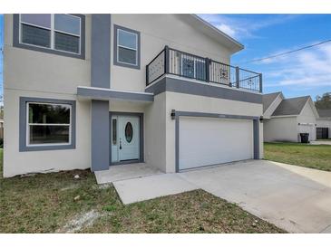 Two-story modern home with attached garage and balcony at 11926 Riverhills Dr, Tampa, FL 33617