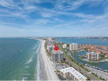 Aerial view of beachfront condo building with ocean and city views at 1660 Gulf Blvd # 304, Clearwater Beach, FL 33767