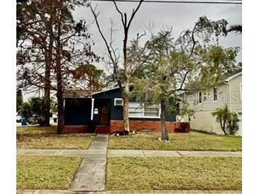 Charming single-story home with brick base and sidewalk leading to the front door at 1701 Shore Acres Ne Blvd, St Petersburg, FL 33703