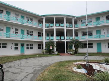 Oasis community condo building, featuring a two-story design and circular driveway at 1900 59Th N Ave # 212, St Petersburg, FL 33714