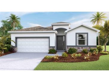 One-story home with a two-car garage and landscaped front yard at 2565 Chapel Oak Bnd, Wesley Chapel, FL 33543