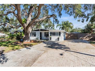 Charming bungalow with a large oak tree and modern updates at 6706 S Kissimmee St, Tampa, FL 33616