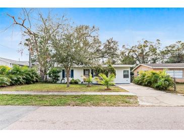 Cute bungalow with a landscaped lawn and driveway at 911 16Th Nw Ave, Largo, FL 33770