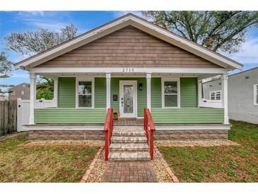 Charming green bungalow with a welcoming front porch and brick pathway at 2715 14Th N Ave, St Petersburg, FL 33713