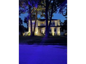 Two-story house with white exterior, landscaping, and a paved driveway at 4224 W Kensington Ave, Tampa, FL 33629