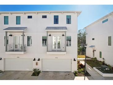 Modern three-story townhome with attached garage and balcony at 4722 Legacy Park Dr, Tampa, FL 33611