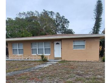 Tan single story house with white door and small yard at 5130 Dr Martin Luther King Jr St S, St Petersburg, FL 33705