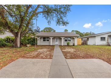 Updated bungalow features a new walkway, landscaping, and fenced backyard at 5712 17Th N Ave, St Petersburg, FL 33710