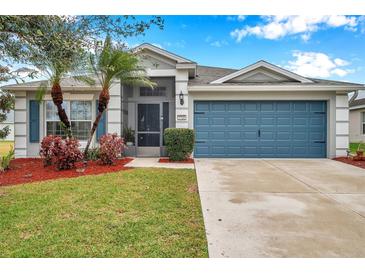 Single-story house with gray siding, blue garage door, and landscaped yard at 5720 107Th E Ter, Parrish, FL 34219