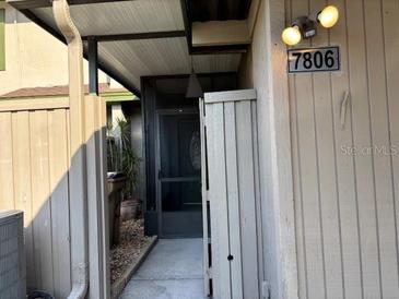 Home's entrance features a screened front door, providing privacy and allowing natural light at 7806 Amberlea Ct, Temple Terrace, FL 33637