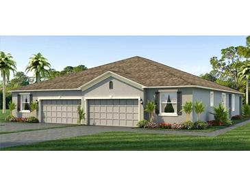 Two-story home with a three-car garage and attractive landscaping at 31556 Ancient Sage Rd, Wesley Chapel, FL 33545