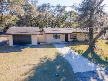 Aerial view of a ranch-style house with a detached garage and spacious yard at 38214 Jendral Ave, Zephyrhills, FL 33542