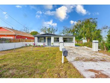 Charming bungalow with stone accents and a well-maintained lawn at 8306 N Klondyke St, Tampa, FL 33604