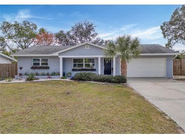 Updated home with gray exterior, white garage door, and landscaping at 1331 Brunswick Dr, Clearwater, FL 33756