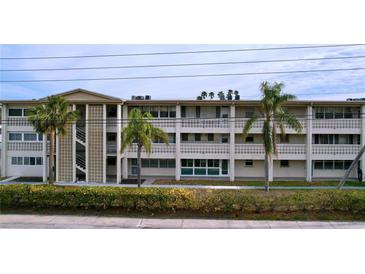 Two-story residential building with palm trees and landscaping at 4455 Duhme Rd # 303, St Petersburg, FL 33708