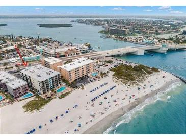 Aerial view of beachfront property with pool and ocean access at 12924 Gulf Blvd # 307, Madeira Beach, FL 33708