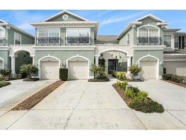 Attractive three-unit townhome building with attached garages and landscaping at 2135 Park Crescent Dr, Land O Lakes, FL 34639