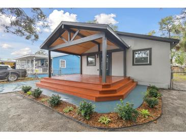 Updated home exterior with new landscaping and covered porch at 3020 Deleuil Ave, Tampa, FL 33610