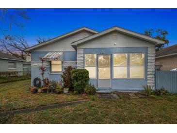 Charming blue house with a well-maintained lawn at 704 E Broad St, Tampa, FL 33604