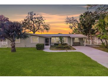 Charming ranch home with a metal roof and well-manicured lawn at 8839 W Millpoint Rd, Riverview, FL 33578