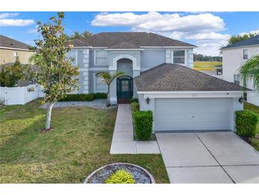 Two-story house with gray siding, dark green door, and a two-car garage at 11120 Kempton Vista Dr, Riverview, FL 33579