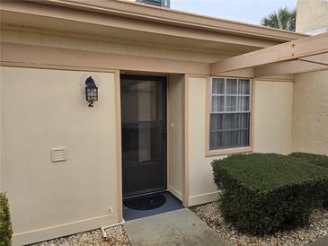 Neat condo building exterior with landscaping and walkway at 11122 Pembridge Ct # 2, Port Richey, FL 34668