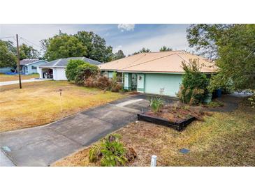 Ranch-style house with a metal roof and a large yard at 13494 Tyringham St, Spring Hill, FL 34609