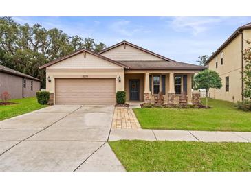 One-story house with a two-car garage and a covered porch at 15579 Stone House Dr, Brooksville, FL 34604