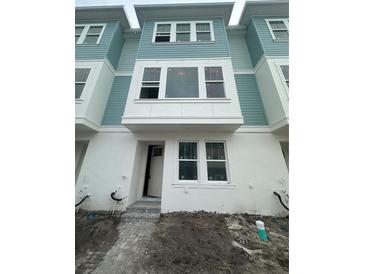 Modern two-story townhome with light teal siding and white trim at 2123 1St N Ave, St Petersburg, FL 33713