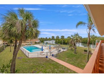 Community pool and patio area with lush landscaping and waterfront views at 2900 45Th S St # 22, Gulfport, FL 33711