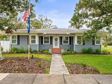 Charming ranch home with gray siding, manicured lawn, and walkway at 320 N Madison Ave, Clearwater, FL 33755