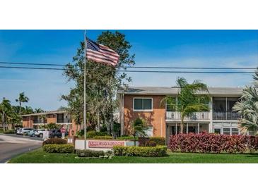 Lake Overlook Condominium complex with lush landscaping and parking at 4550 Overlook Ne Dr # 257, St Petersburg, FL 33703