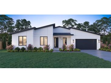 Modern house exterior with white walls, dark garage door, and landscaping at 6708 Burlington Ave, St Petersburg, FL 33710