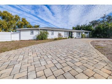 Ranch style home with paver driveway and landscaped yard at 7601 9Th N Ave, St Petersburg, FL 33710